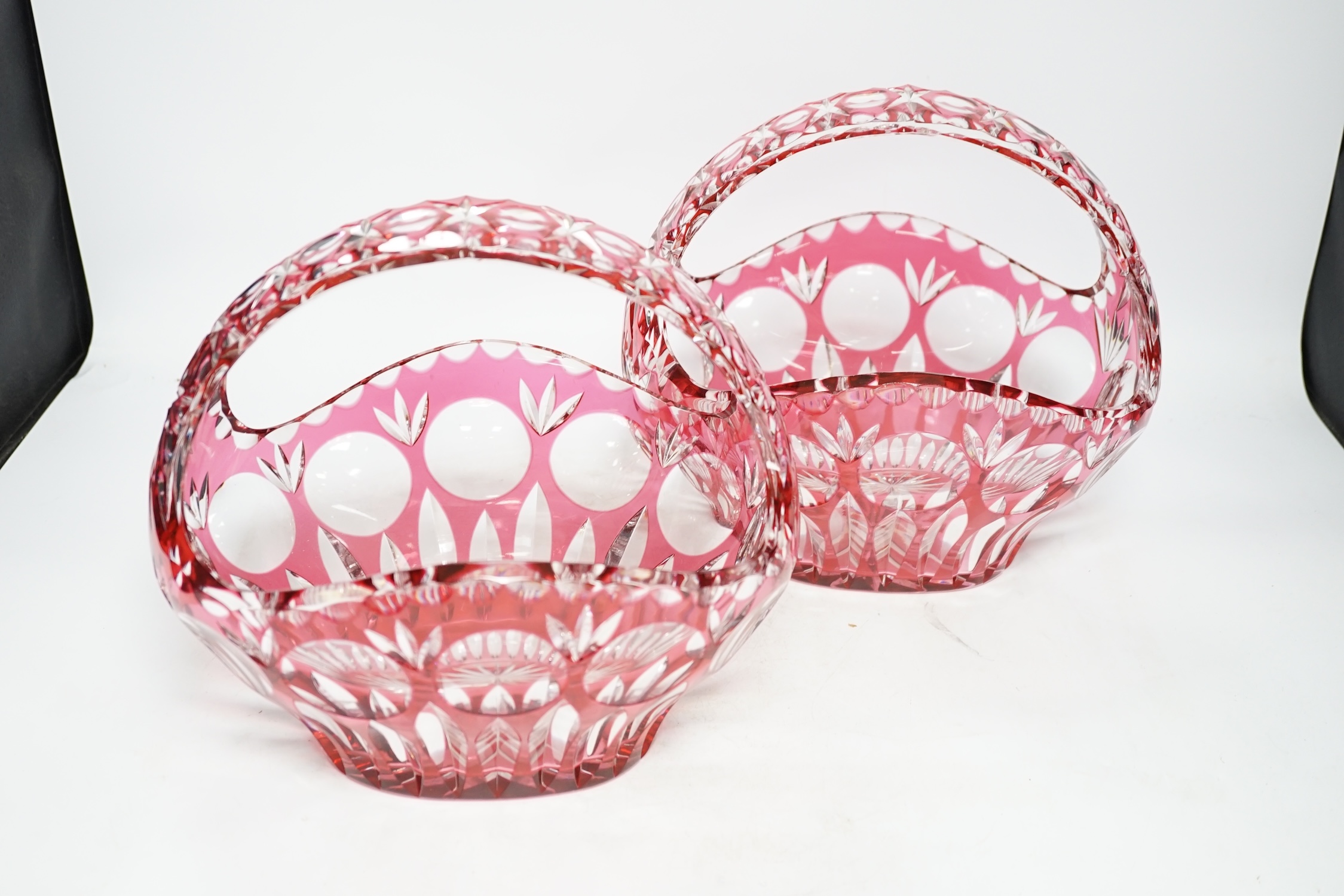 A pair of overlaid cranberry flashed baskets, 26cm wide. Condition - good